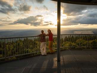 Une mère se tient avec sa fille sur la plate-forme panoramique de la tour Hant. Le soleil va bientôt se coucher.