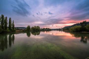 Der Sonnenuntergang über Stein am Rhein spiegelt sich im ruhigen Wasser des Untersees.