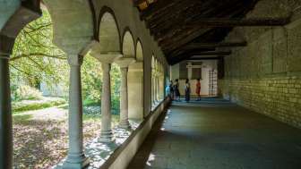 Visite guidée de la ville de Schaffhouse Cinq personnes se tiennent dans le cloître de Schaffhouse. Un guide raconte quelque chose au groupe.