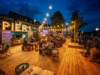 Rhykantine Schaffhouse Un café et un bar pop-up ont été installés sur une estrade en bois. La nourriture est servie dans des conteneurs transformés.